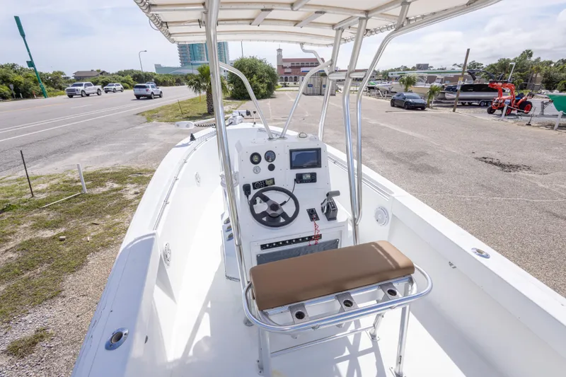 Slide: The Image of 1998 Contender 21 CC boat with center console, parked near a road. - 21