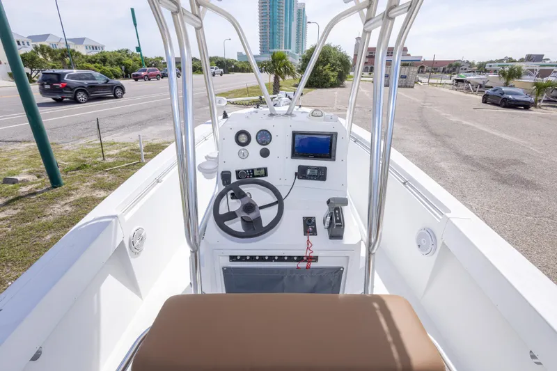 Slide: The Image of 1998 Contender 21 CC boat console with steering wheel, gauges, and navigation equipment. - 23