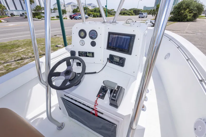 Slide: The Image of 1998 Contender 21 CC boat console with steering wheel, gauges, and navigation equipment. - 24