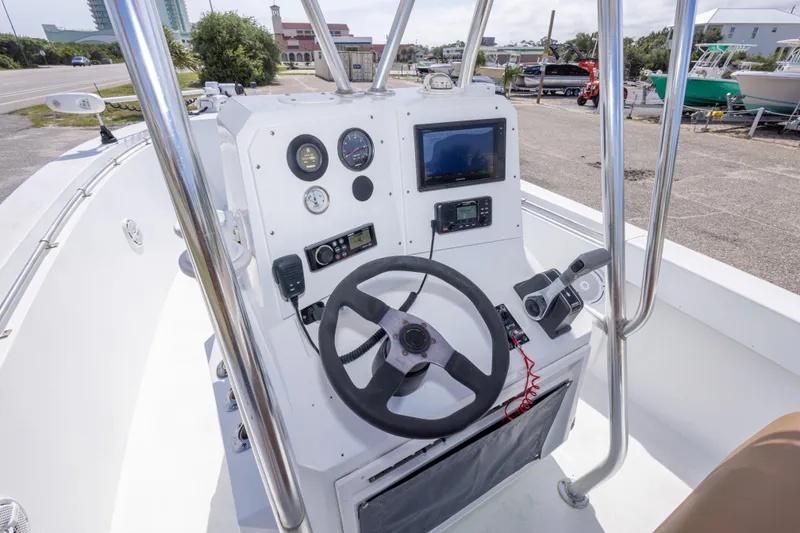 Slide: The Image of 1998 Contender 21 CC boat console with steering wheel, gauges, and navigation equipment. - 25