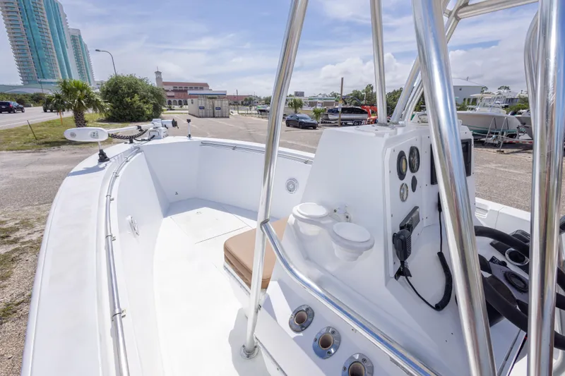 Slide: The Image of 1998 Contender 21 CC boat with console and gauges, parked near buildings and palm trees. - 29