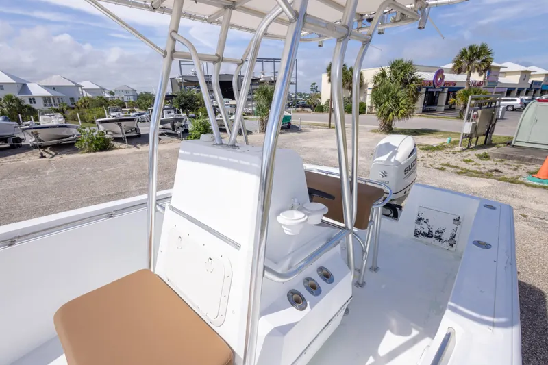 Slide: The Image of 1998 Contender 21 CC boat with seating and console, parked outdoors. - 35