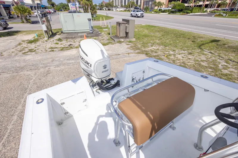 Slide: The Image of 1998 Contender 21 CC boat with Suzuki 250 outboard motor, parked near a road. - 38