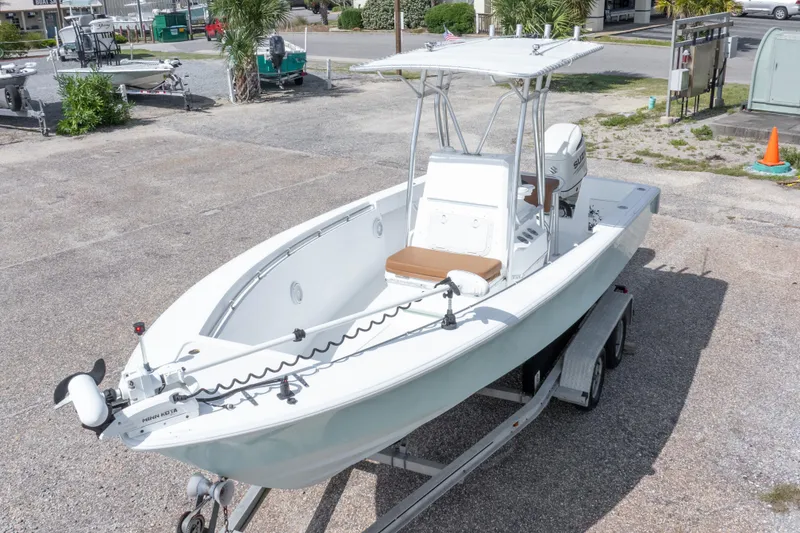 Slide: The Image of 1998 Contender 21 CC boat on trailer, featuring center console and outboard motor. - 4