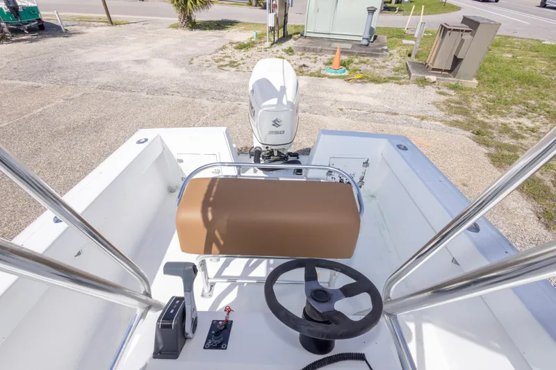 Slide: The Image of 1998 Contender 21 CC boat interior with steering wheel and Suzuki outboard motor. - 40
