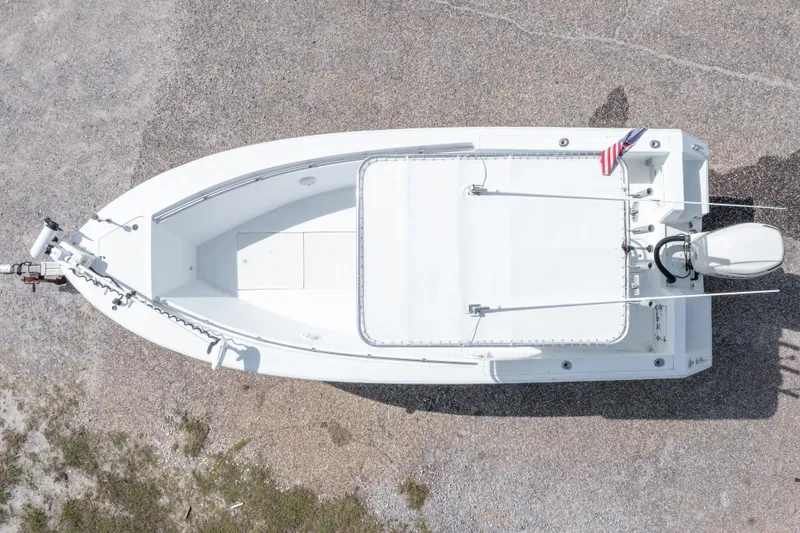 Slide: The Image of Overhead view of a 1998 Contender 21 CC boat on gravel, featuring a sleek white design. - 6