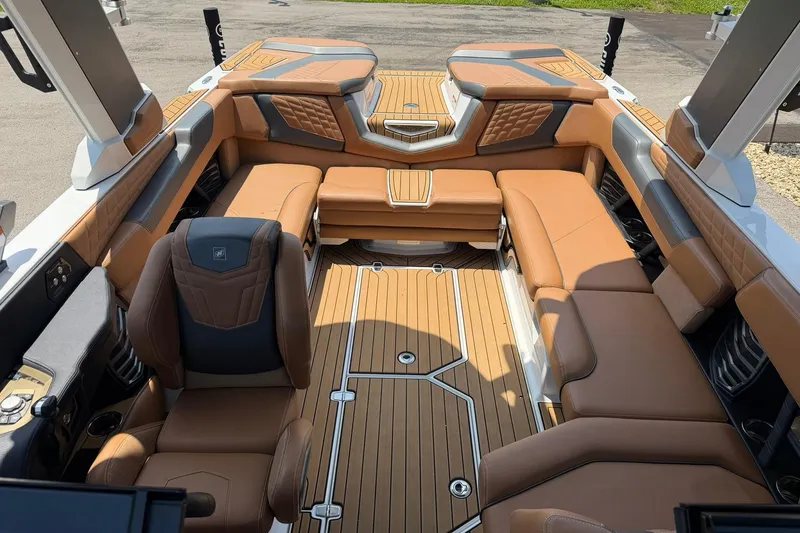 Slide: The Image of 2022 Nautique Super Air Nautique G23 interior with luxurious tan seating and sleek design. - 10