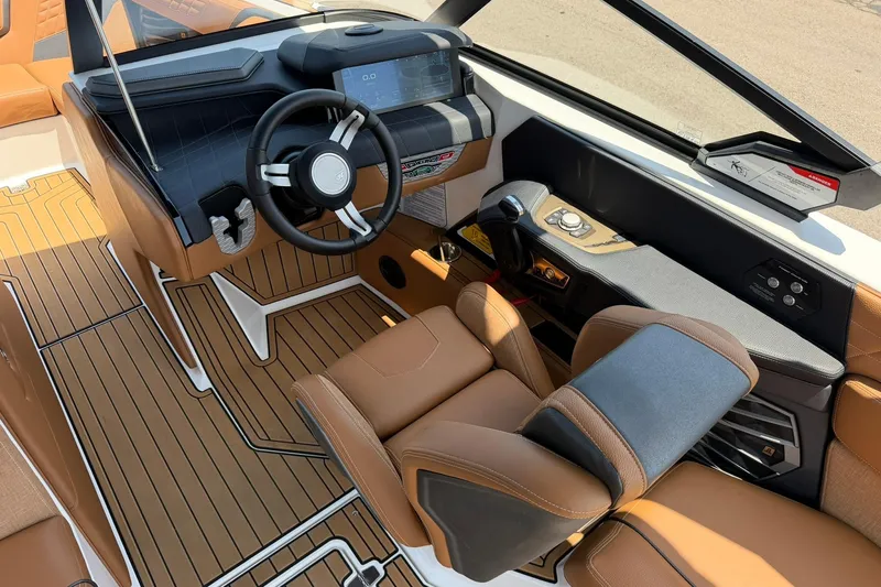 Slide: The Image of 2022 Nautique Super Air Nautique G23 cockpit with luxurious brown seating and modern dashboard. - 11