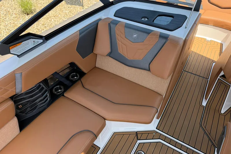 Slide: The Image of Luxurious interior of 2022 Nautique Super Air Nautique G23 with tan leather seating. - 12