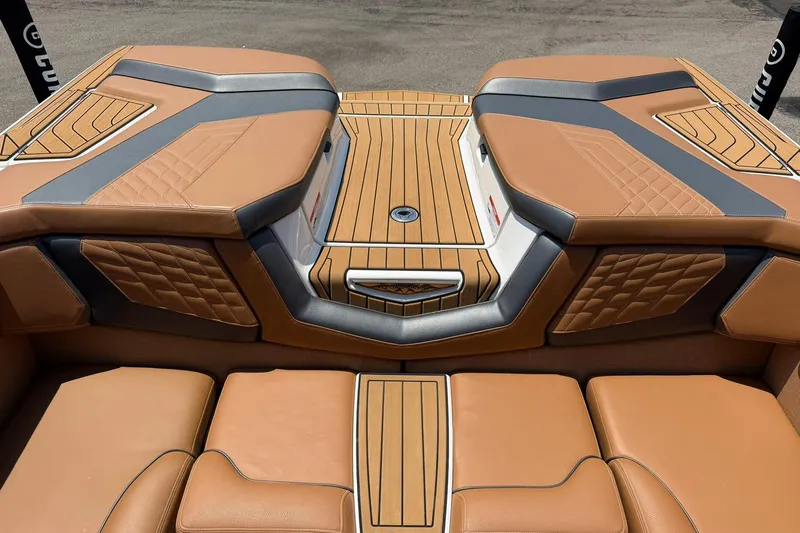 Slide: The Image of 2022 Nautique Super Air Nautique G23 boat interior with tan and gray upholstery. - 13