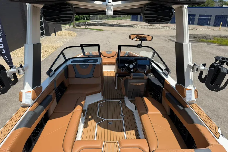 Slide: The Image of Interior of 2022 Nautique Super Air Nautique G23 boat with luxurious seating and modern dashboard. - 15