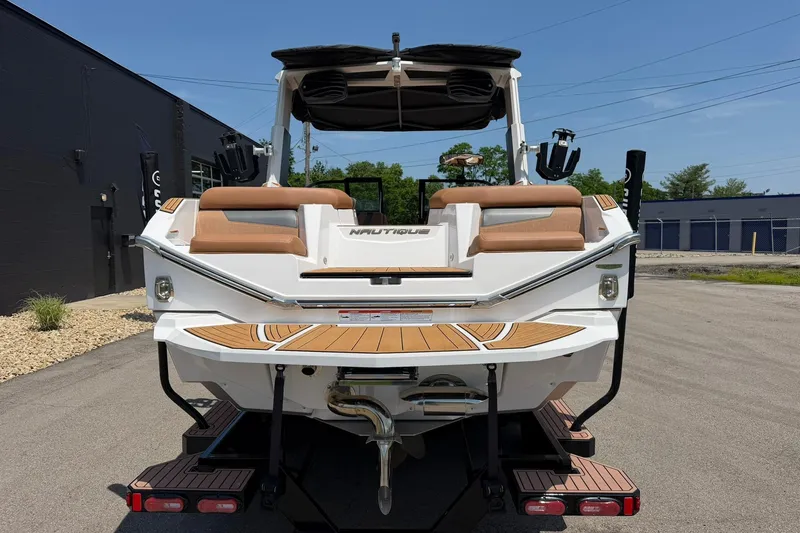Slide: The Image of 2022 Nautique Super Air Nautique G23 boat, rear view, parked outdoors on a sunny day. - 4