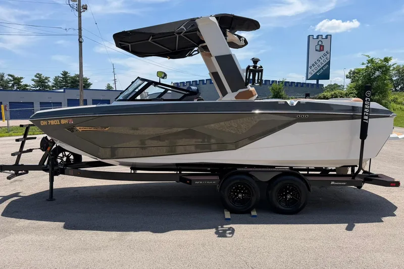 Slide: The Image of 2022 Nautique Super Air Nautique G23 boat on trailer, parked outdoors. - 6