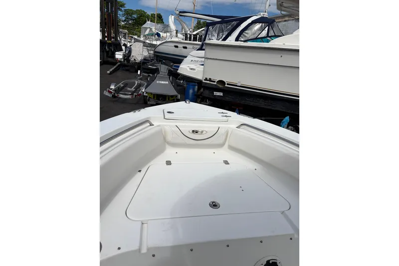 Slide: The Image of 2015 Sea Hunt Ultra 196 boat deck, parked among other boats at a marina. - 7