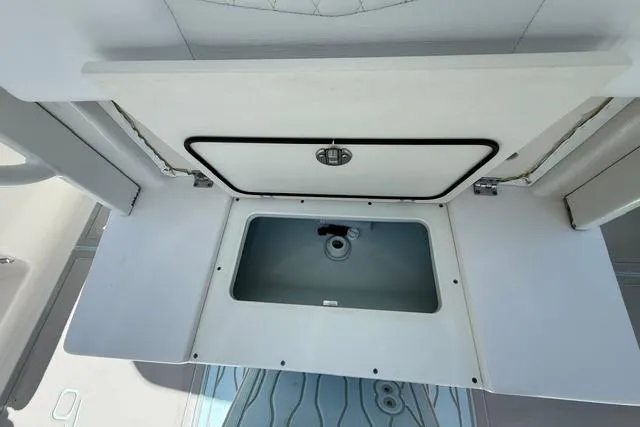 Slide: The Image of 2019 Robalo R272 Center Console boat storage compartment, open with visible interior. - 10