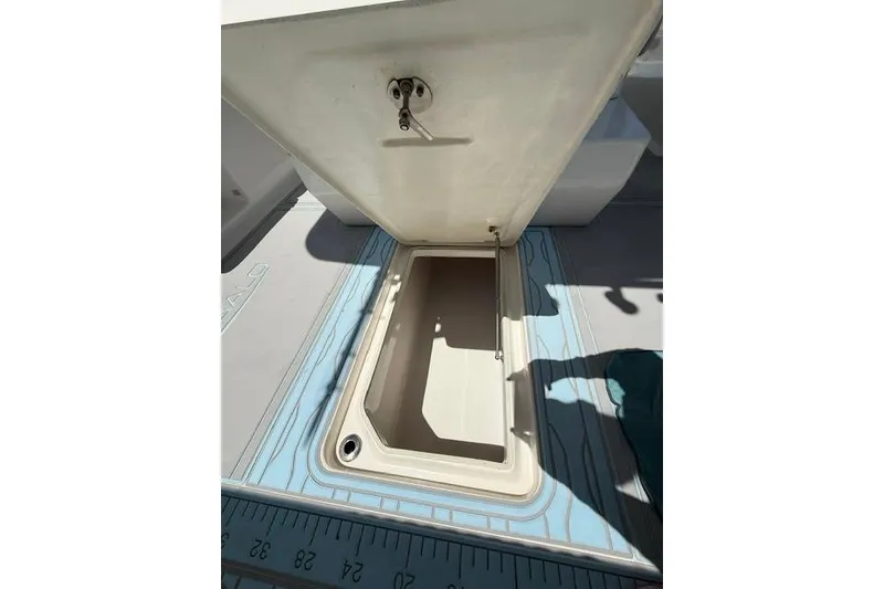 Slide: The Image of Open storage compartment on 2019 Robalo R272 Center Console boat deck. - 12