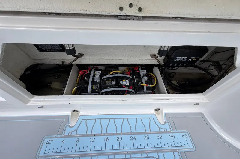 Slide: The Image of 2019 Robalo R272 Center Console boat battery compartment with NOCO Genius charger. - 14