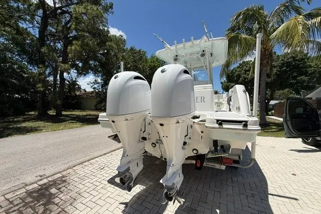 Slide: The Image of 2019 Robalo R272 Center Console boat with dual outboard engines on a sunny day. - 19