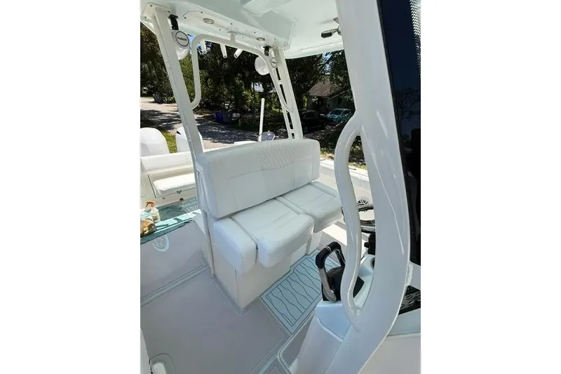 Slide: The Image of 2019 Robalo R272 Center Console boat interior with white seating and modern design. - 4
