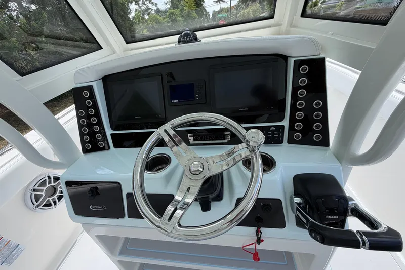 Slide: The Image of 2019 Robalo R272 Center Console helm with steering wheel and dual displays. - 5