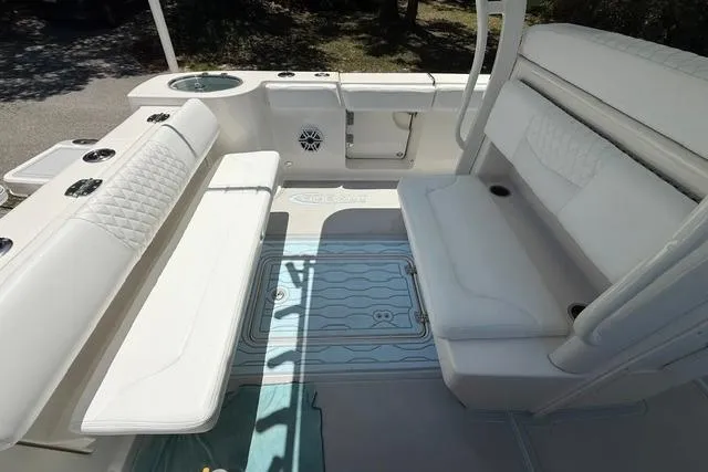 Slide: The Image of 2019 Robalo R272 Center Console boat interior with white seating and deck features. - 6
