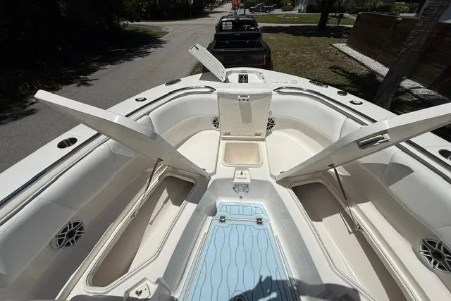 Slide: The Image of 2019 Robalo R272 Center Console boat with open storage compartments and seating area. - 8