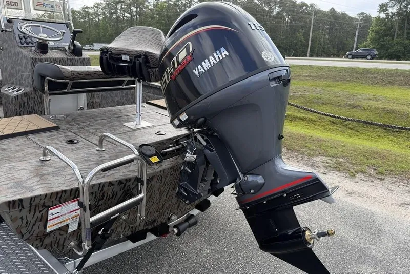 Slide: The Image of 2026 Xpress H190B Bay boat with Yamaha outboard motor, parked on roadside. - 10
