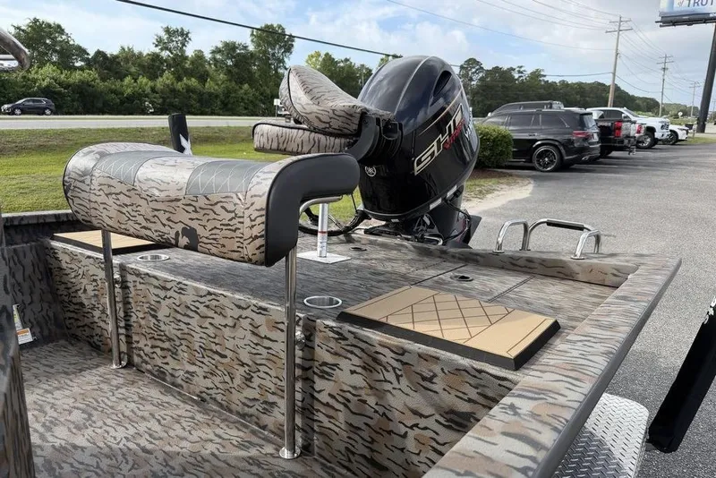 Slide: The Image of 2026 Xpress H190B Bay boat with camo seats and powerful outboard motor. - 11