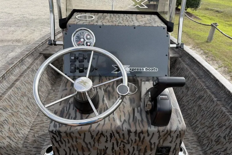 Slide: The Image of 2026 Xpress H190B Bay boat dashboard with steering wheel and controls. - 3