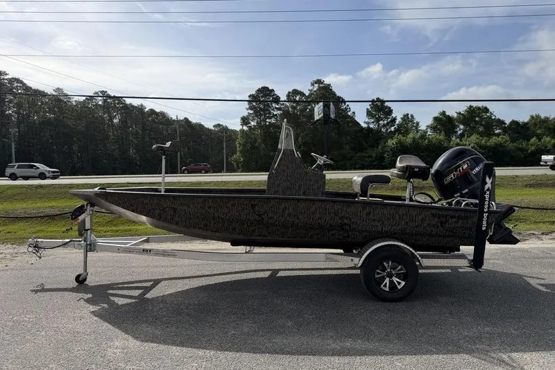 Slide: The Image of 2026 Xpress H190B Bay boat on trailer, parked roadside under clear sky. - 4
