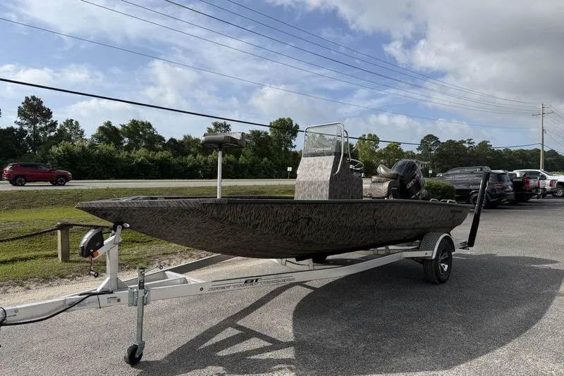 Slide: The Image of 2026 Xpress H190B Bay boat on trailer, parked outdoors under cloudy sky. - 8