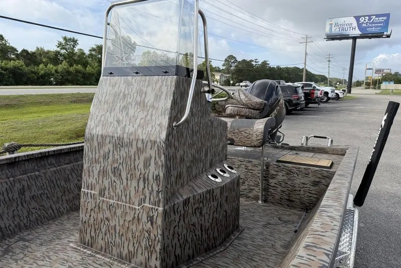 Slide: The Image of 2026 Xpress H190B Bay boat with camouflage design, parked near a road. - 9