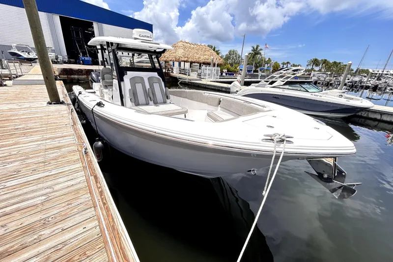 Slide: The Image of 2024 Sea Fox 328 Commander boat docked at marina under blue sky. - 16