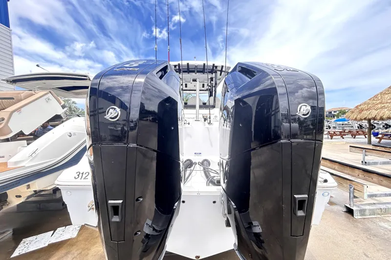 Slide: The Image of 2024 Sea Fox 328 Commander with dual outboard engines at a marina. - 3