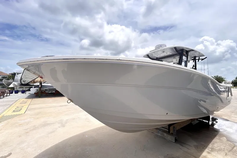 Slide: The Image of 2024 Sea Fox 328 Commander boat on display under cloudy sky. - 7
