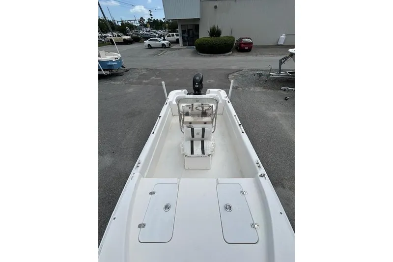 Slide: The Image of 2011 Carolina Skiff JVX16CC boat with center console in a parking lot. - 4