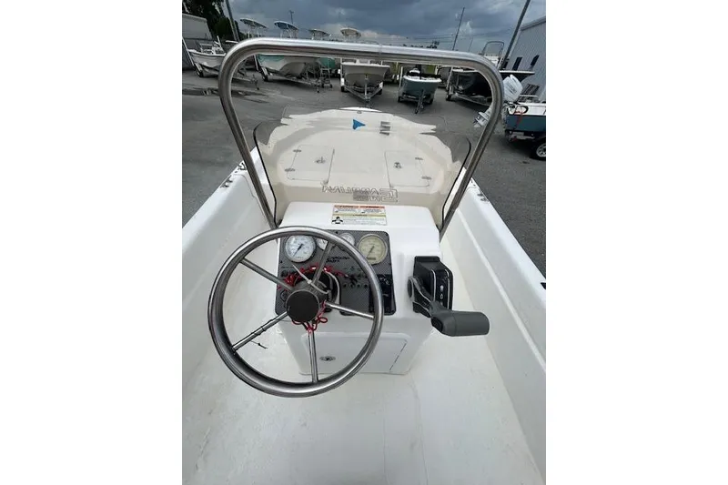 Slide: The Image of 2011 Carolina Skiff JVX16CC boat console with steering wheel and gauges. - 7