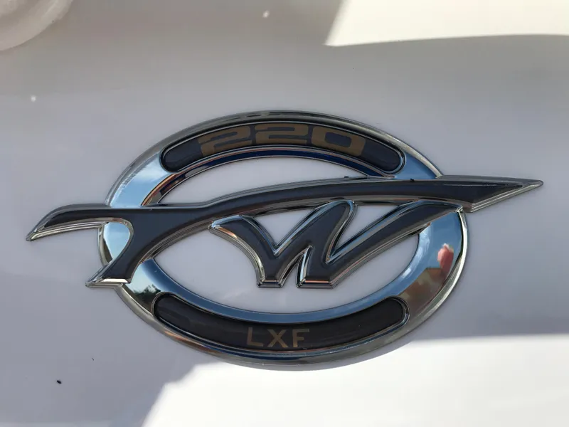 Slide: The Image of Tidewater 220 LXF 2020 boat emblem on white background. - 1