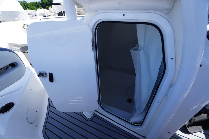 Slide: The Image of 2020 Tidewater 220 LXF boat interior with open cabin door and curtain. - 10