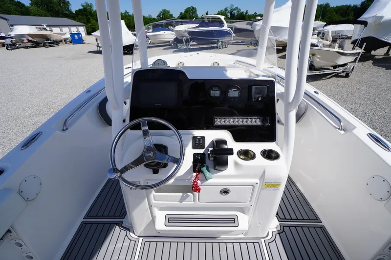 Slide: The Image of 2020 Tidewater 220 LXF boat console with steering wheel and controls. - 12