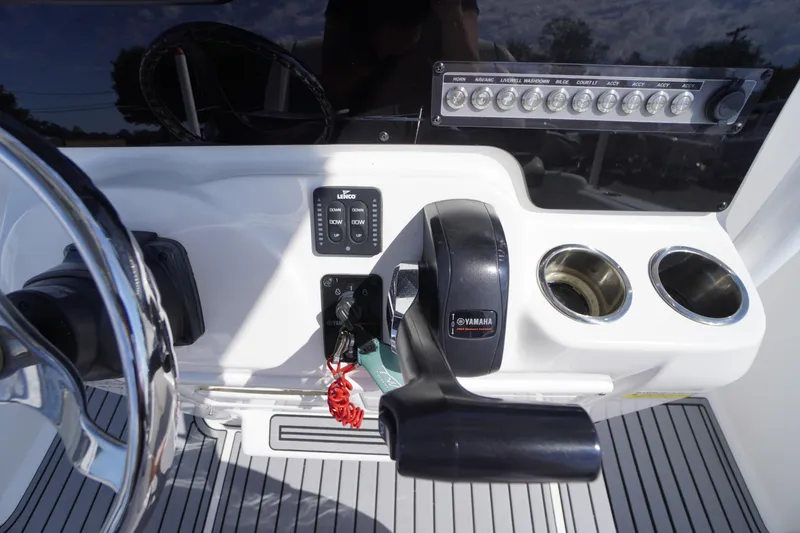 Slide: The Image of 2020 Tidewater 220 LXF boat console with Yamaha controls and cup holders. - 15