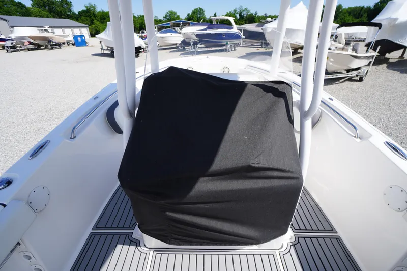 Slide: The Image of 2020 Tidewater 220 LXF boat with covered console, parked in a marina. - 17