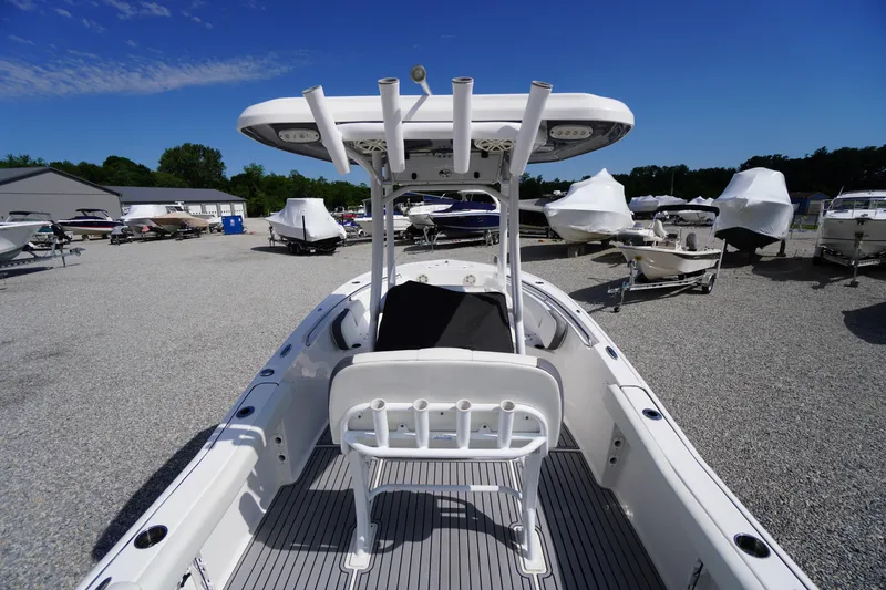Slide: The Image of 2020 Tidewater 220 LXF boat in a marina, surrounded by other vessels. - 23