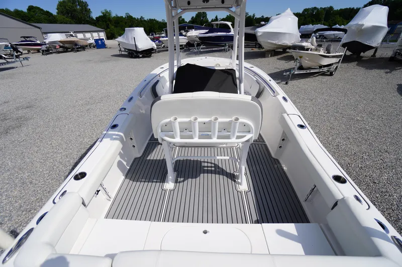 Slide: The Image of 2020 Tidewater 220 LXF boat interior with seating and rod holders in a marina. - 24