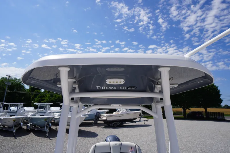 Slide: The Image of 2020 Tidewater 220 LXF boat with T-top under a clear blue sky. - 25