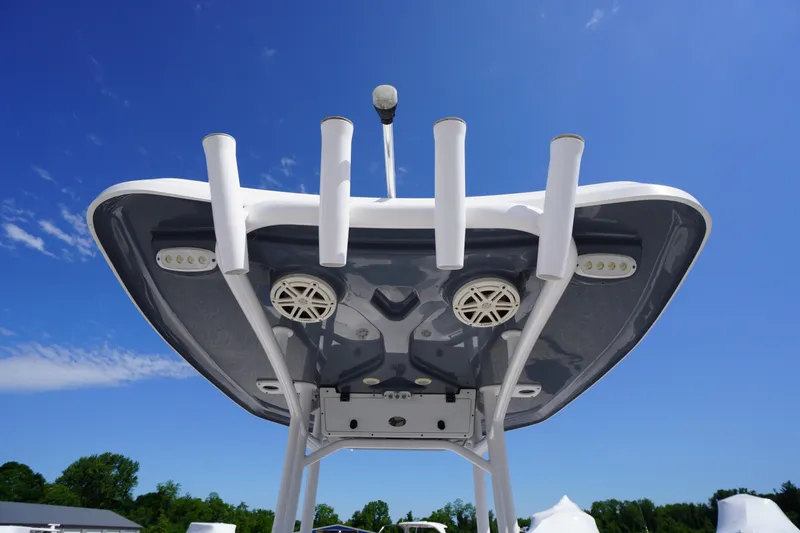 Slide: The Image of 2020 Tidewater 220 LXF boat top view with rod holders and speakers against blue sky. - 26
