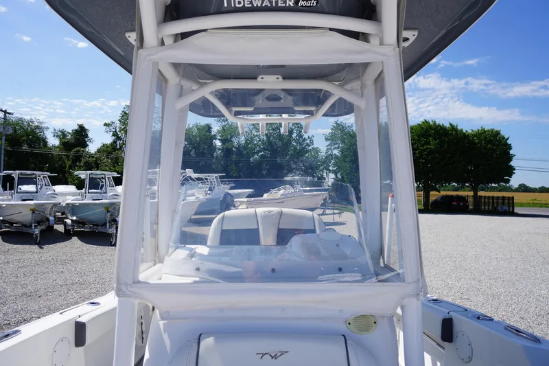 Slide: The Image of 2020 Tidewater 220 LXF boat with T-top, parked outdoors on gravel lot. - 27