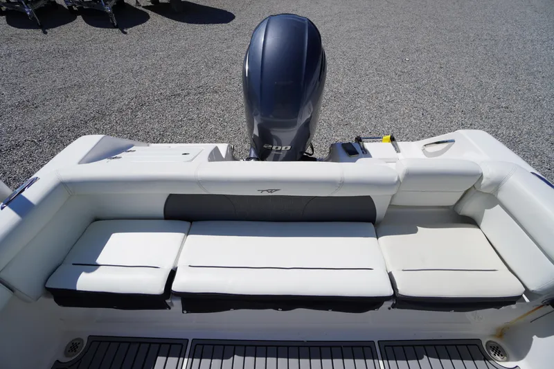 Slide: The Image of 2020 Tidewater 220 LXF boat with cushioned seating and outboard motor. - 30