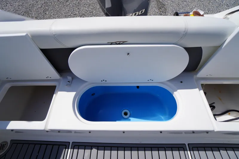 Slide: The Image of 2020 Tidewater 220 LXF boat with open storage compartment and blue interior. - 33