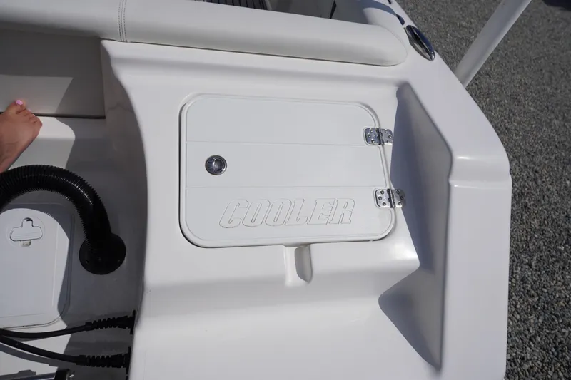 Slide: The Image of Tidewater 220 LXF 2020 boat cooler compartment with white finish and secure latch. - 34